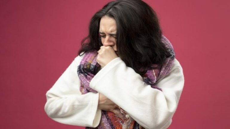 aching-young-ill-woman-wearing-robe-scarf-keeping-hand-chest-fist-mouth-coughing-with-closed-eyes-isolated-pink-wall.jpg