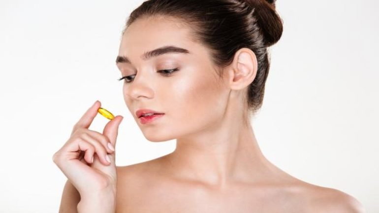 beauty-portrait-pretty-concentrated-woman-with-soft-skin-holding-pill-her-hand-posing.jpg